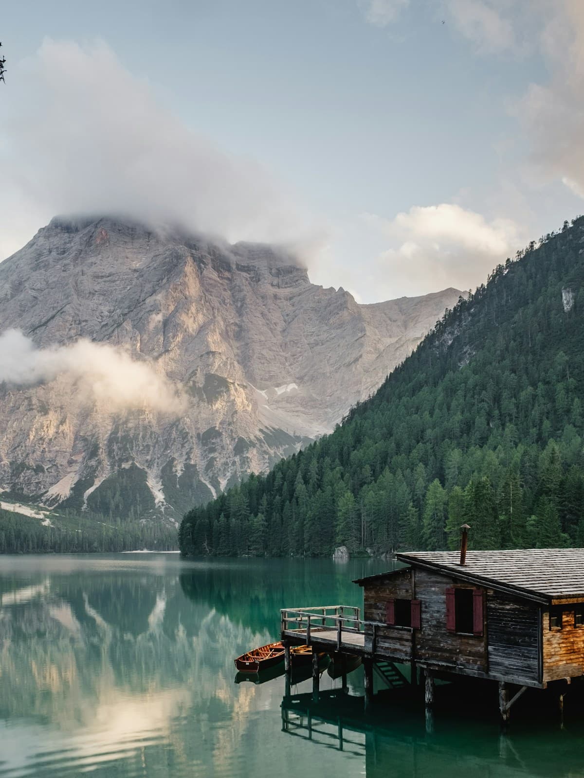 A quiet mountain lake beneath soft clouds