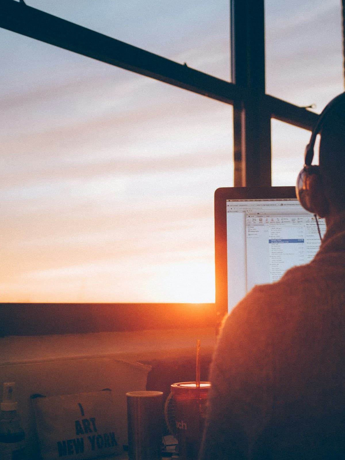 A person working independently beside a warm sunset