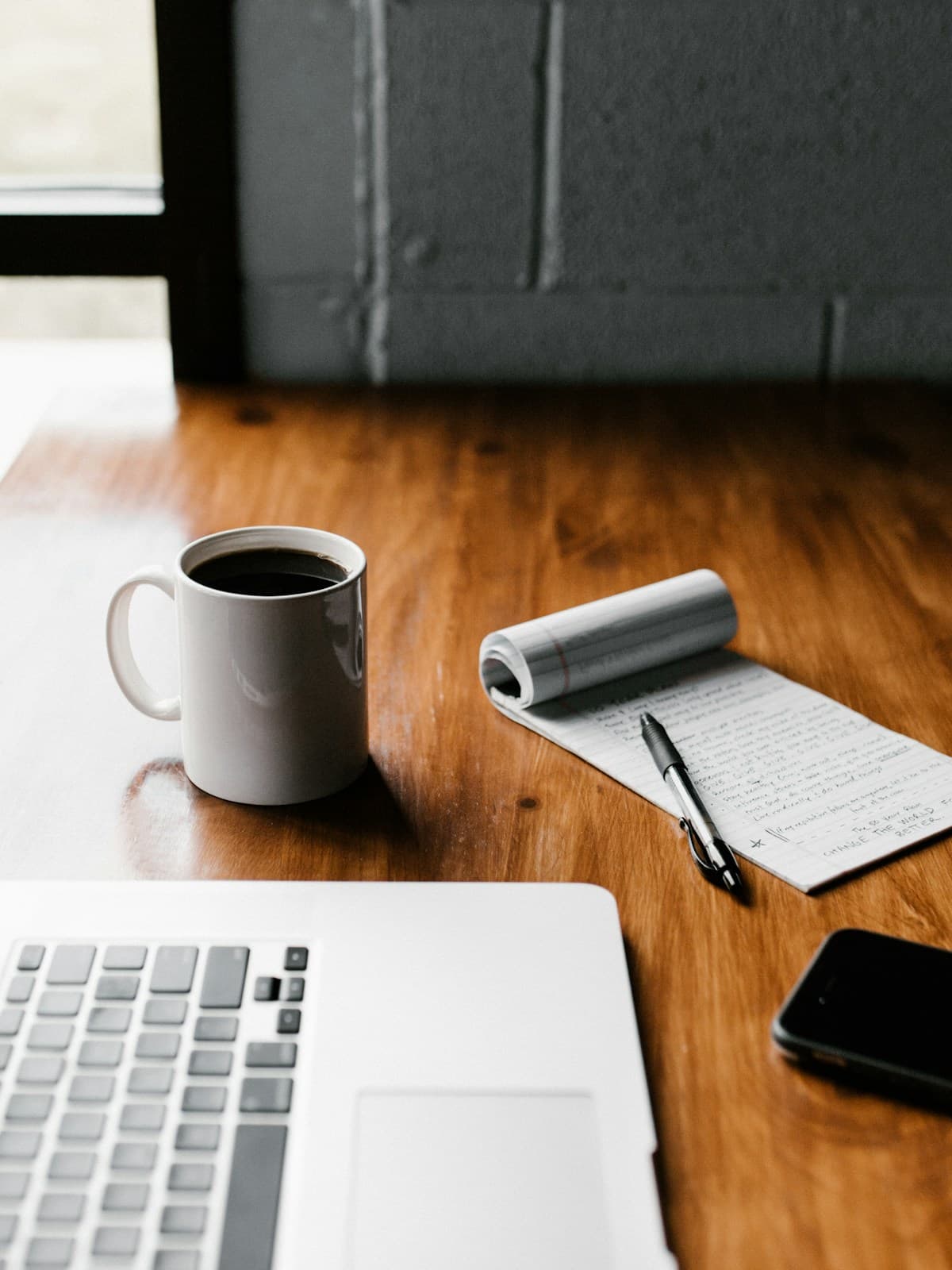 Notes, a laptop, and coffee arranged for focused learning