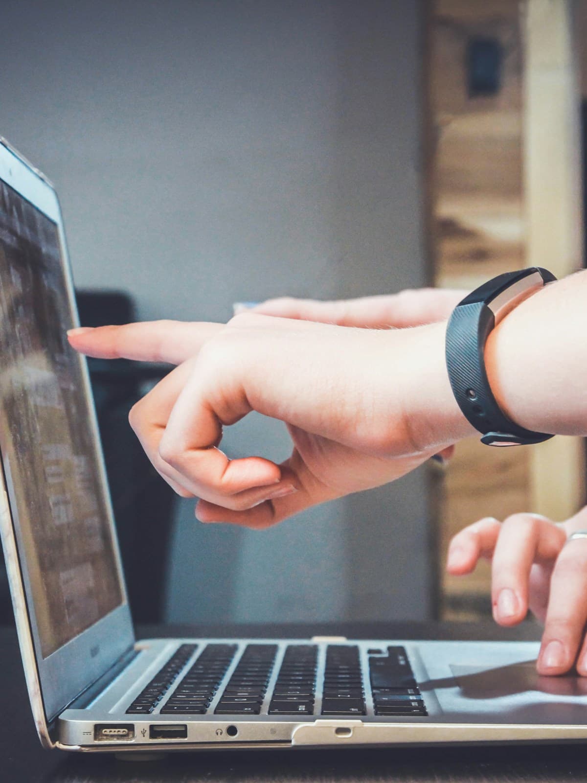 Two people exploring information together on a laptop
