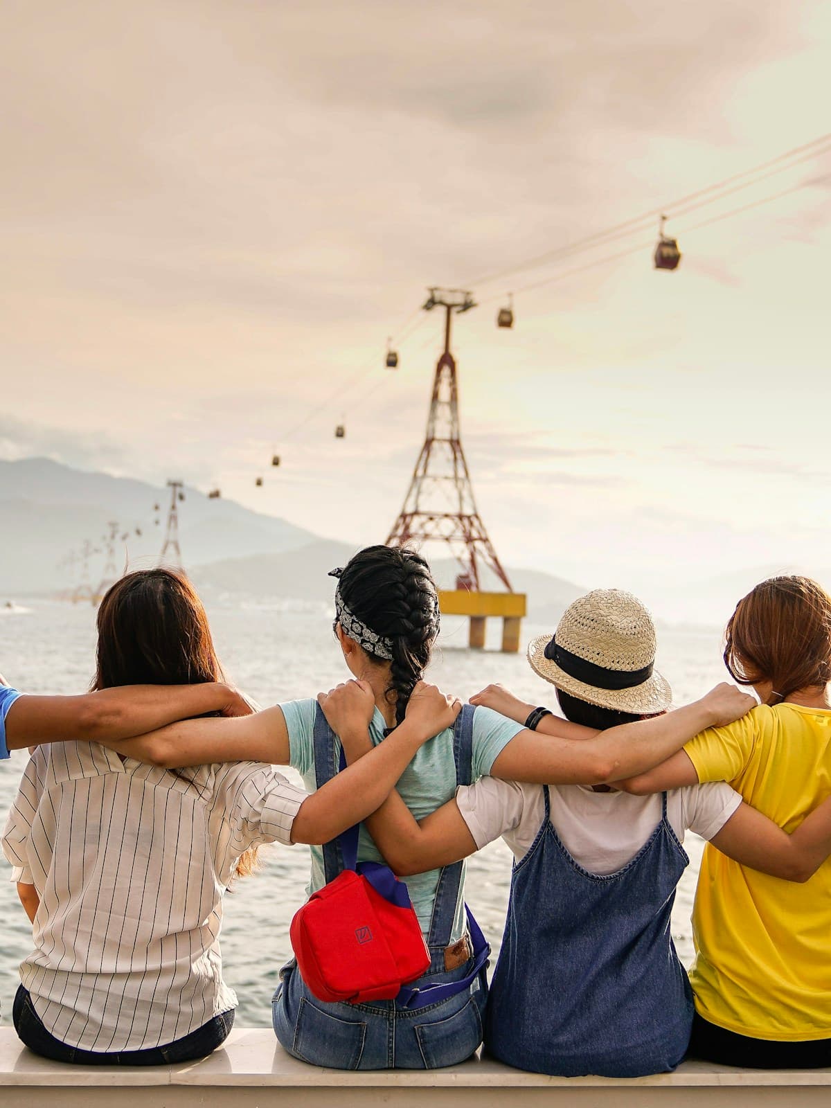 Friends sitting together with their arms around one another