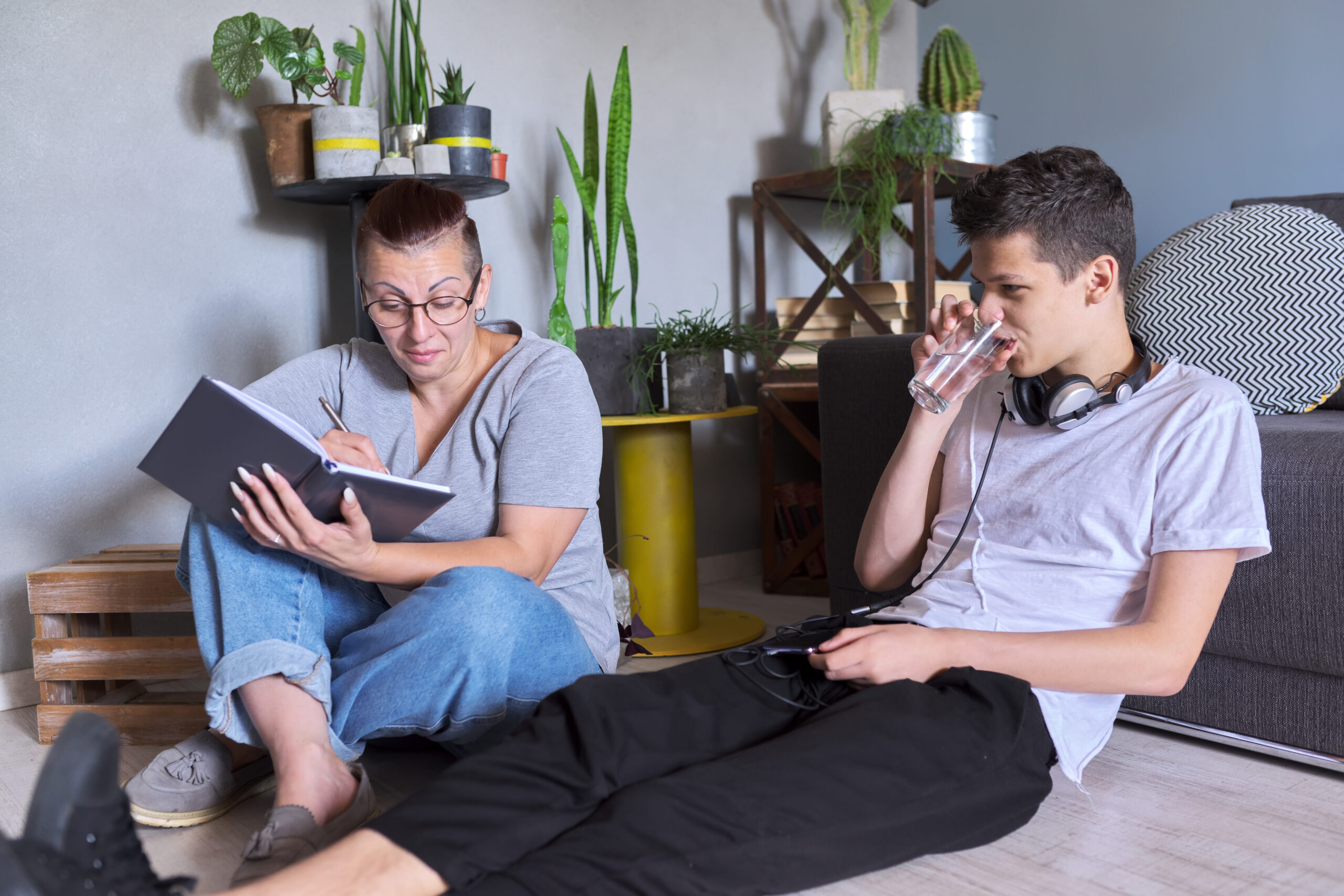 Teen boy talking to psychologist at home, individual therapy session for teenage with doctor